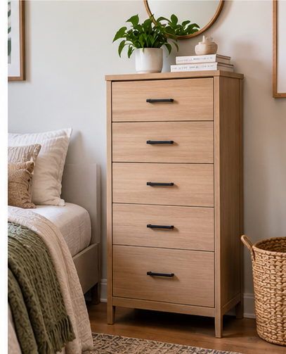 Tall narrow dresser in a small bedroom beside the bed