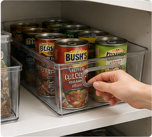 Hand pulling a clear pantry bin forward from a deep shelf